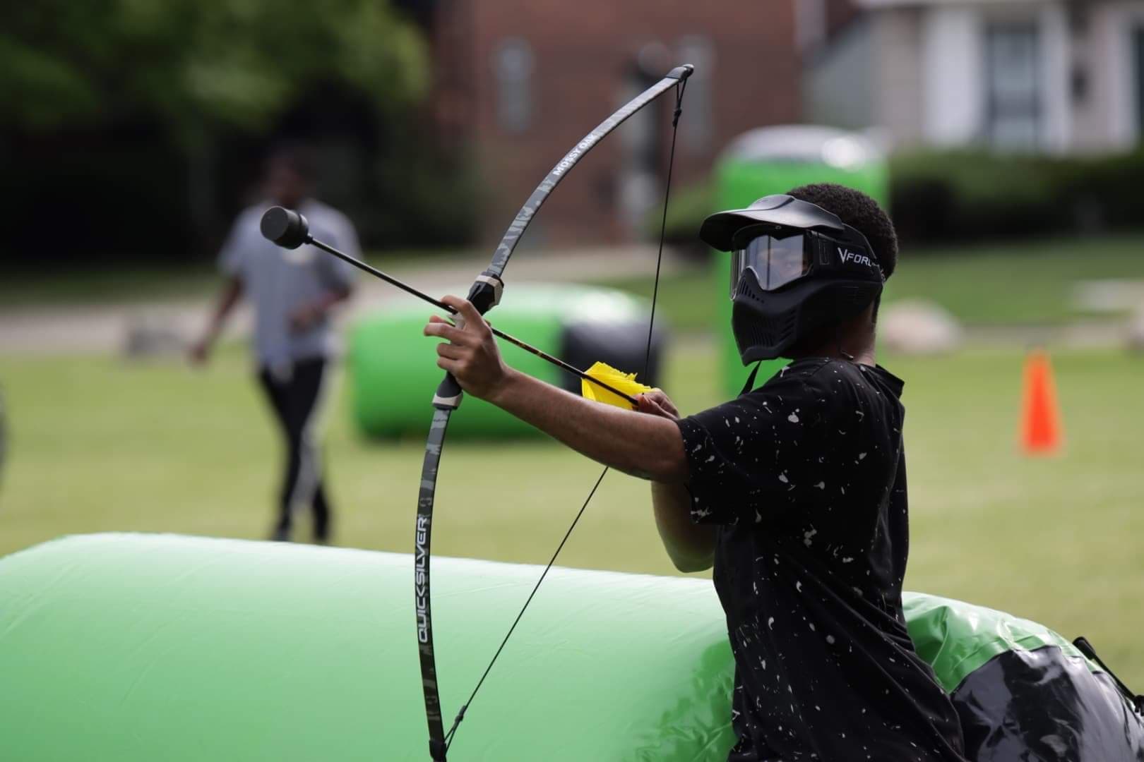 Player aiming with Archery Tag bow
